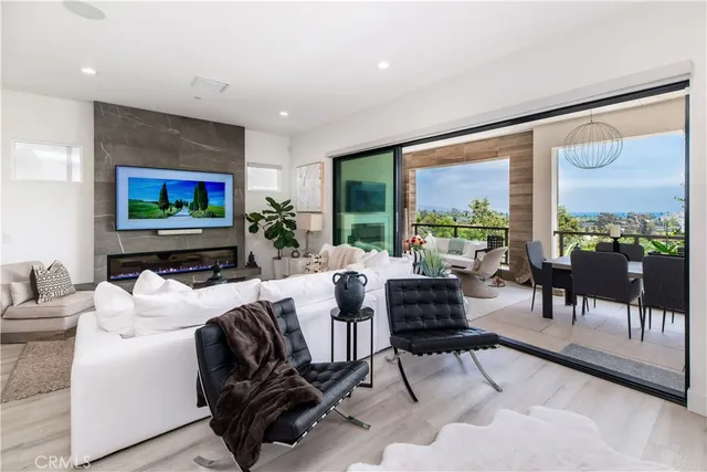 a living room with furniture tv and a large window