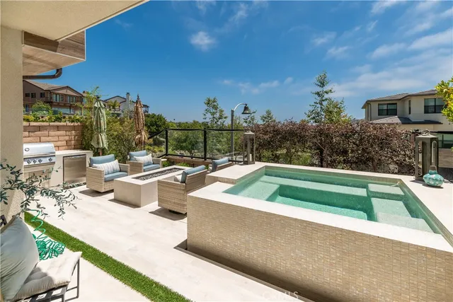 a view of swimming pool with outdoor seating and plants