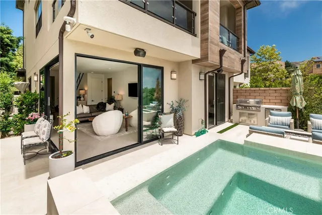 a view of a house with backyard outdoor seating and hardwood floor