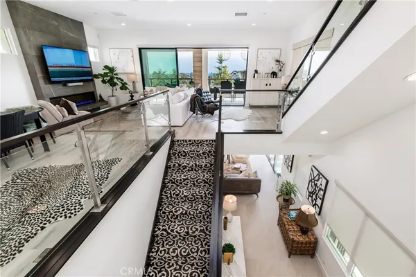 a living room with furniture a rug and a flat screen tv