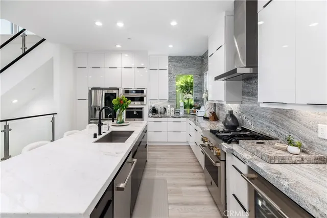 a kitchen with sink stove and cabinets