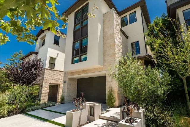 a view of a building with potted plants and a tree