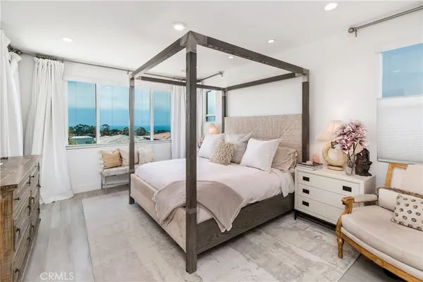 a spacious bedroom with a bed and large window