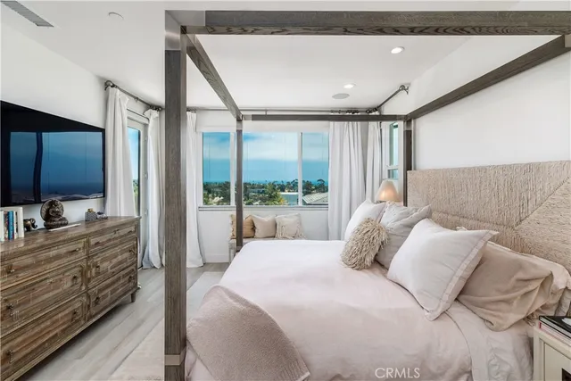 a bedroom with a large bed and a window