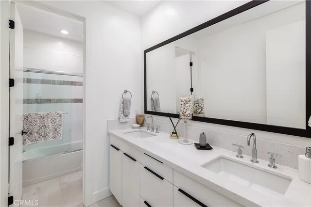 a bathroom with a double vanity sink and a mirror