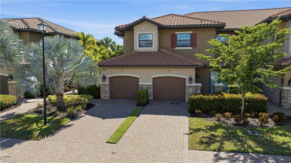 9658 Montelanico Loop, Unit 201 Naples, FL 34119 - Photo 28 of 46 a house view with a garden space