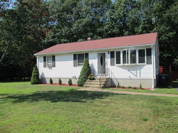 a view of a house with a yard and sitting area