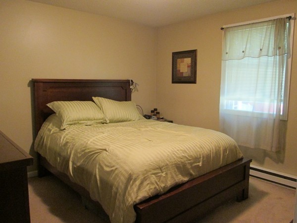 64 Brookside Avenue Webster, MA 01570 - Photo 12 of 30 a large bed sitting in a bedroom next to a bathroom