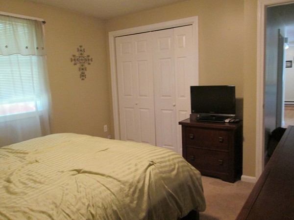64 Brookside Avenue Webster, MA 01570 - Photo 13 of 30 a bedroom with a bed and a flat tv screen on a dresser