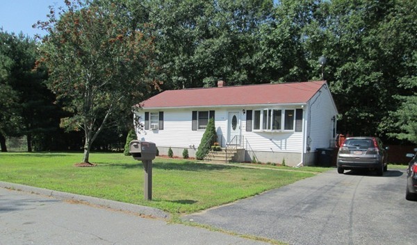 64 Brookside Avenue Webster, MA 01570 - Photo 29 of 30 a front view of a house with a yard table and chairs