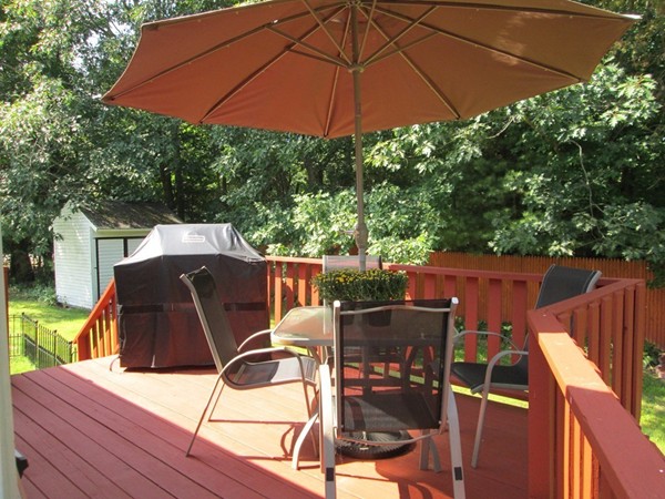 64 Brookside Avenue Webster, MA 01570 - Photo 4 of 30 a view of a roof deck with table and chairs under an umbrella