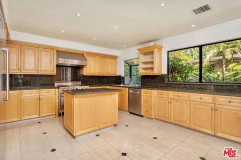a kitchen with sink cabinets and window