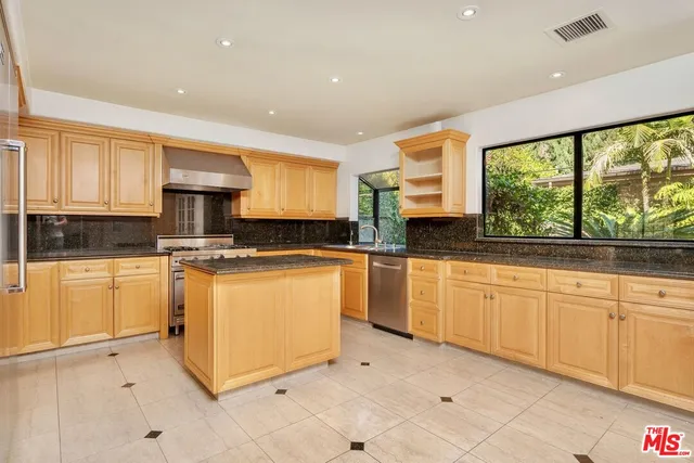 a kitchen with sink cabinets and window