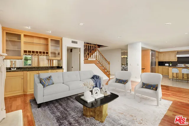 a living room with furniture and view of kitchen