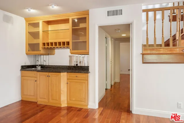 a view of a kitchen with granite countertop a refrigerator and a sink
