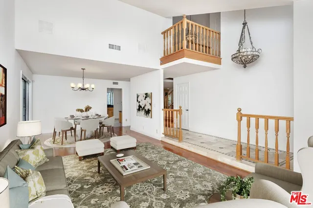 a living room with furniture a rug and a chandelier