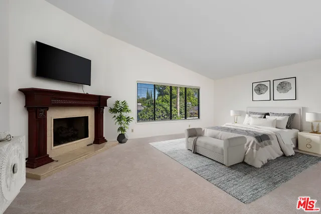 a bed room with a bed and a fireplace