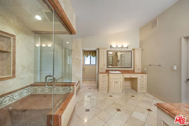 a bathroom with a tub sink and mirror