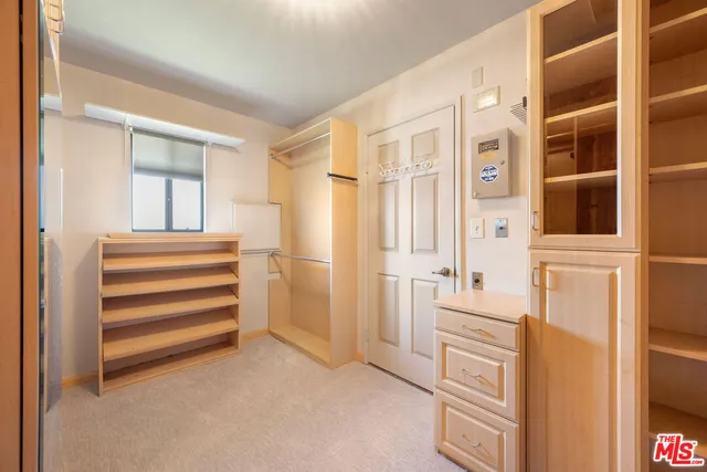 a view of a bedroom with furniture and door