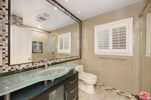 a bathroom with a shower and a toilet