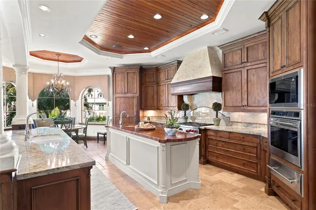 a kitchen with stainless steel appliances granite countertop a stove top oven a sink dishwasher and cabinets with wooden floor