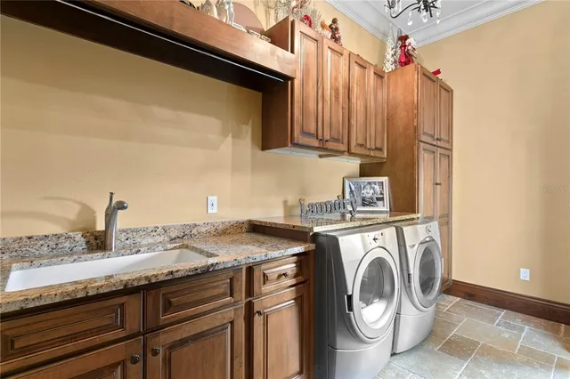 a bathroom with a granite countertop toilet a sink and a window