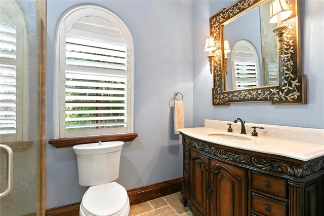 a bedroom with a large bed a flat screen tv and a large window