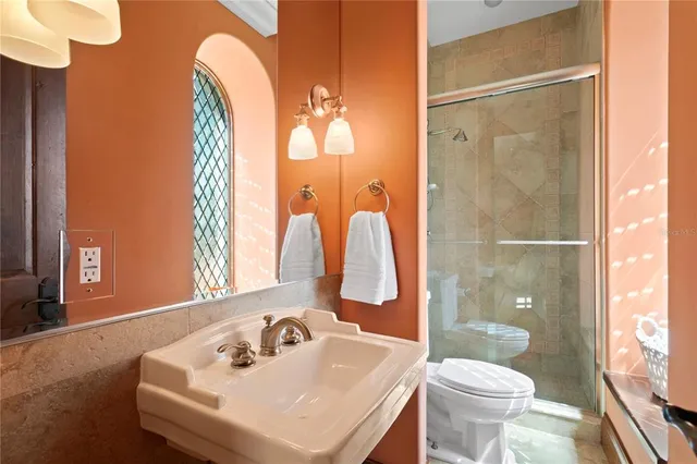 a living room with patio furniture and flowers