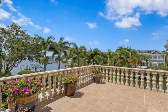a view of a patio with couches table and chairs and potted plants