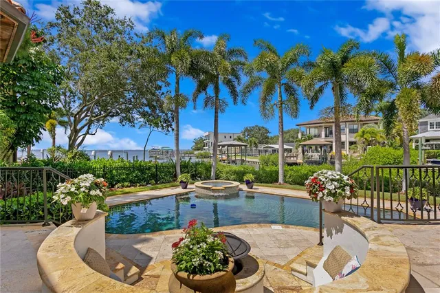 an aerial view of a house with a garden and lake view