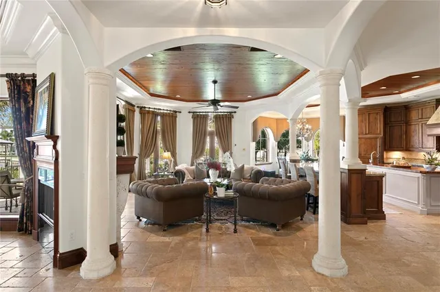 a living room with furniture and a floor to ceiling window