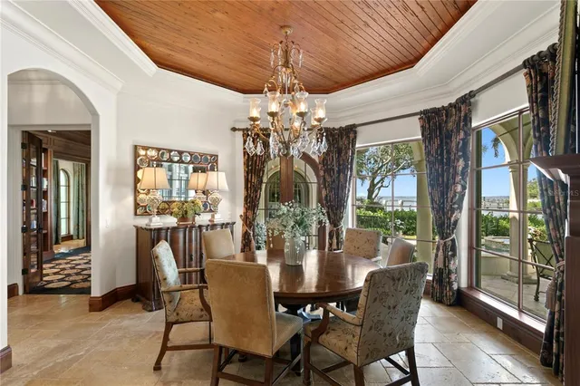 a view of a dining room with furniture wooden floor and chandelier