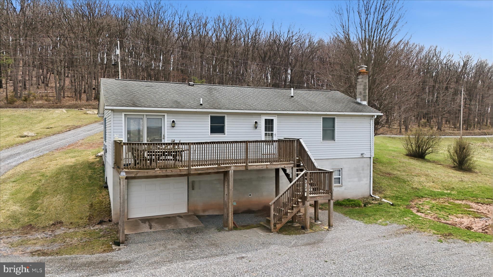 529 Braddock School Road Slanesville, WV 25444 - Photo 44 of 44 a view of a patio with table and chairs with wooden floor and fence