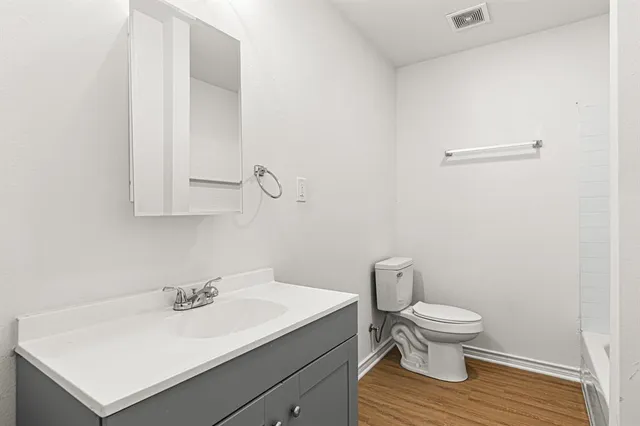 a bathroom with a sink toilet and mirror