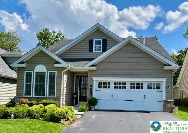 a view of a house with potted plants and a garden