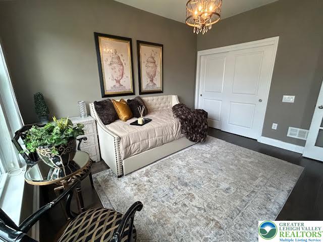 1051 Resolution Drive Bethlehem, PA 18017 - Photo 17 of 33 a bedroom with a bed potted plant on dresser and a chandelier