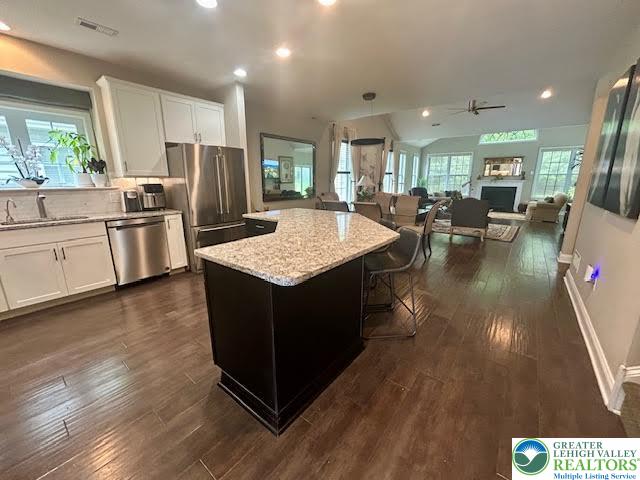 1051 Resolution Drive Bethlehem, PA 18017 - Photo 9 of 33 a kitchen with kitchen island granite countertop wooden floors and wide window