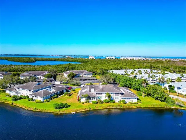 an aerial view of residential houses with outdoor space and swimming pool