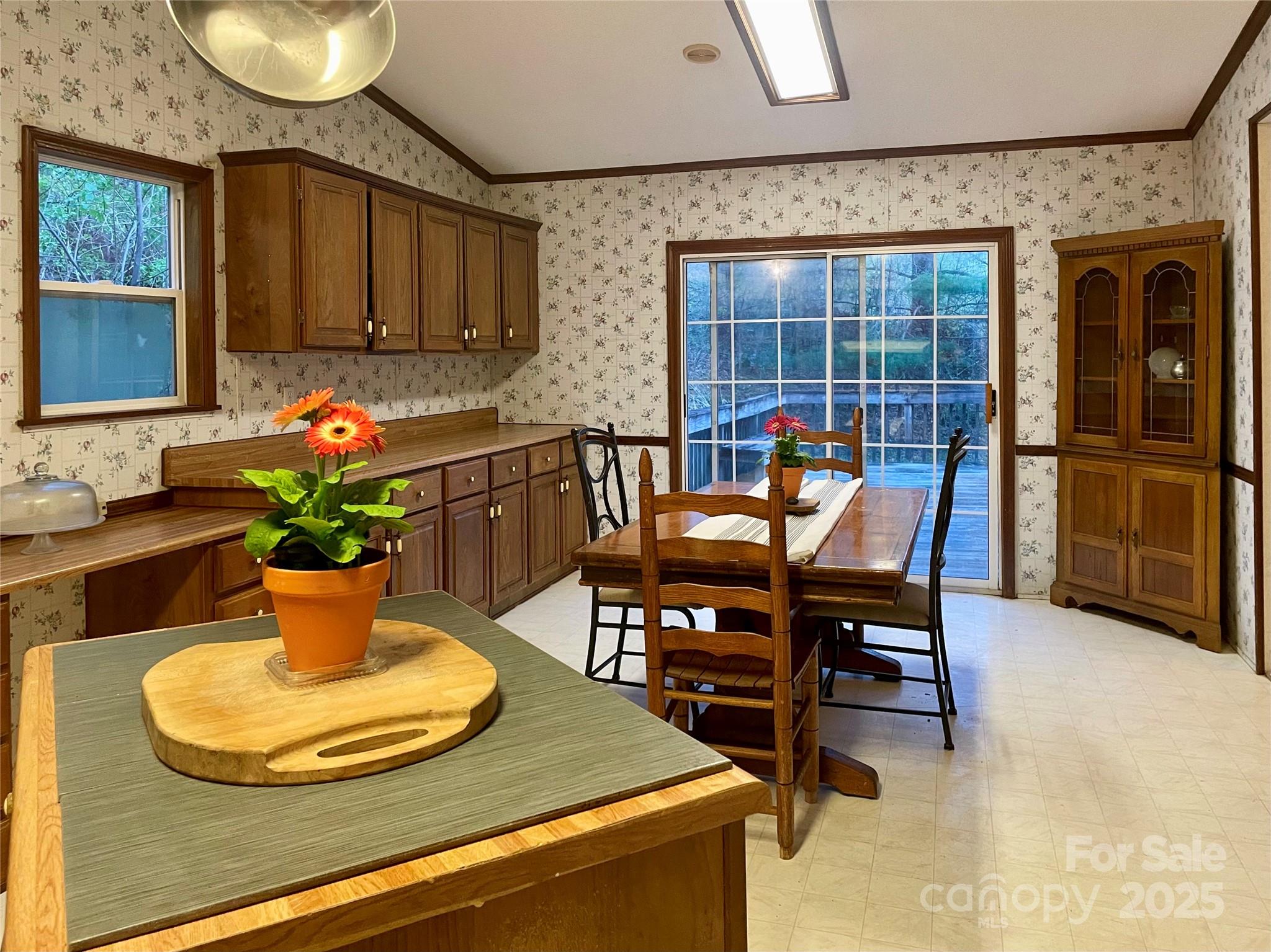 784 Fred Holcombe Road Mars Hill, NC 28754 - Photo 14 of 35 a view of a dining room with furniture and a potted plant