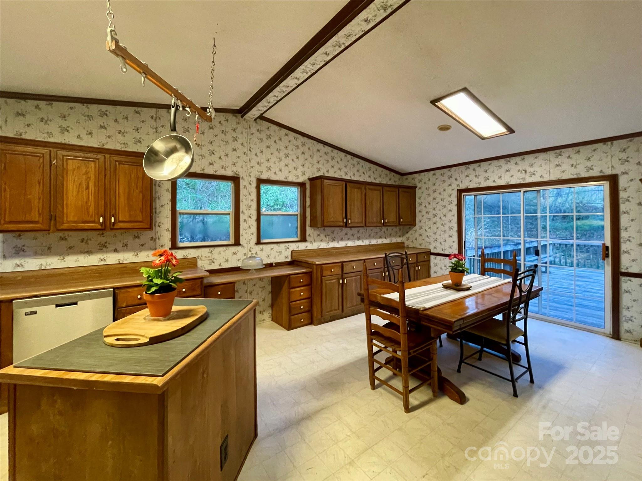 784 Fred Holcombe Road Mars Hill, NC 28754 - Photo 15 of 35 a kitchen with a stove a sink a dining table and chairs