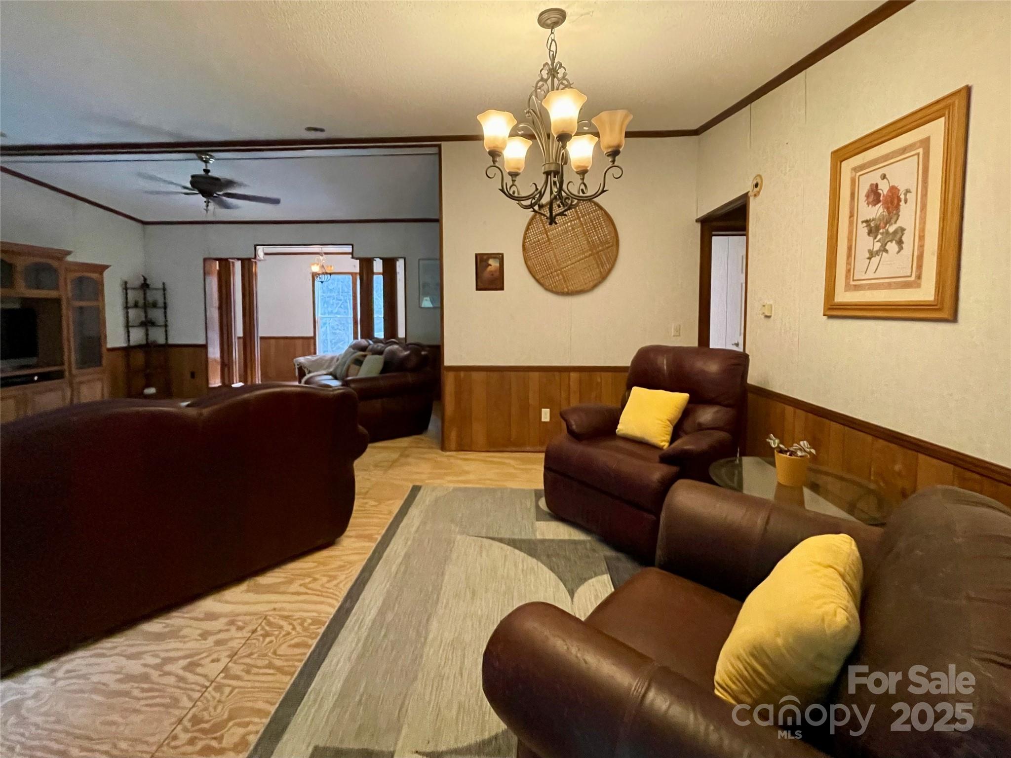 784 Fred Holcombe Road Mars Hill, NC 28754 - Photo 16 of 35 a living room with furniture chandelier and a mirror