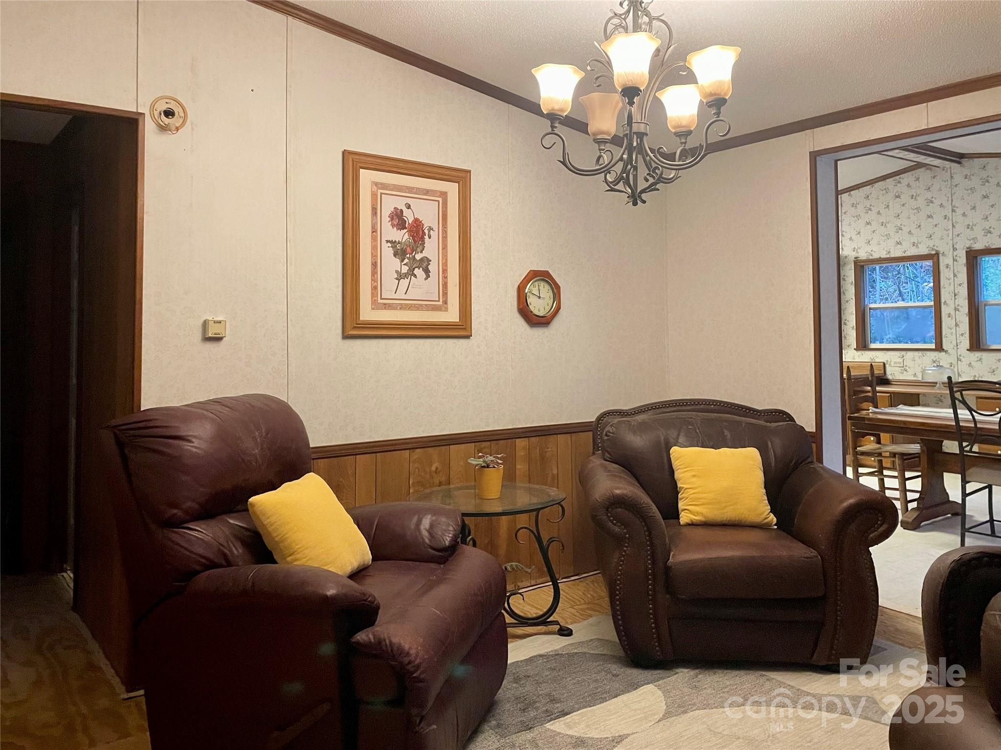 784 Fred Holcombe Road Mars Hill, NC 28754 - Photo 19 of 35 a living room with furniture and a chandelier