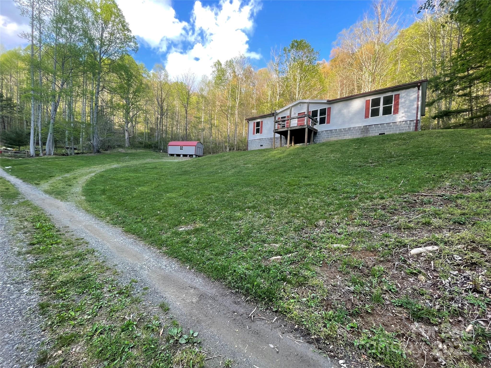 784 Fred Holcombe Road Mars Hill, NC 28754 - Photo 2 of 35 a view of a house with a yard