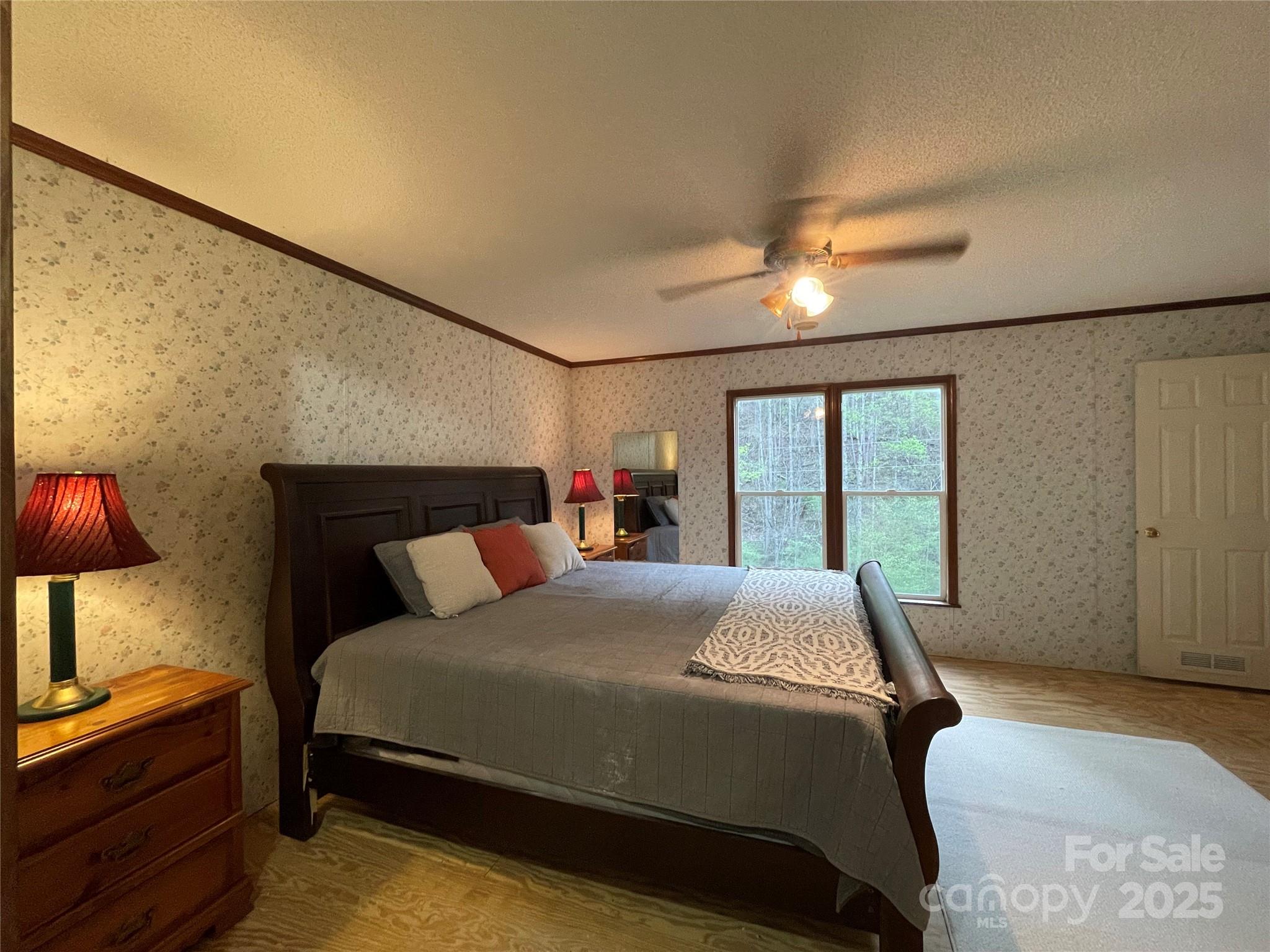 784 Fred Holcombe Road Mars Hill, NC 28754 - Photo 28 of 35 a bedroom with a bed and window