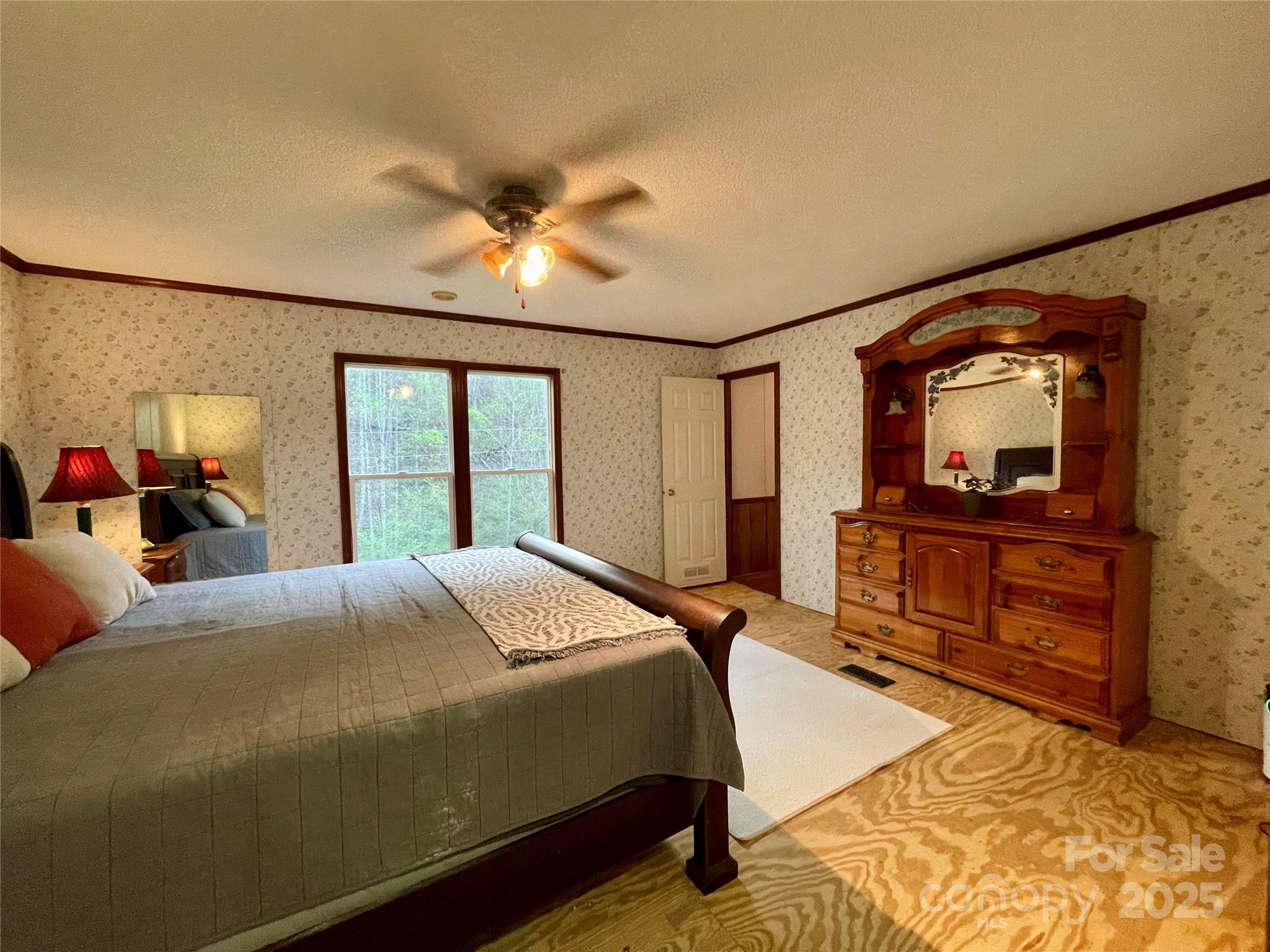 784 Fred Holcombe Road Mars Hill, NC 28754 - Photo 29 of 35 a bedroom with a bed and a large mirror on the dresser