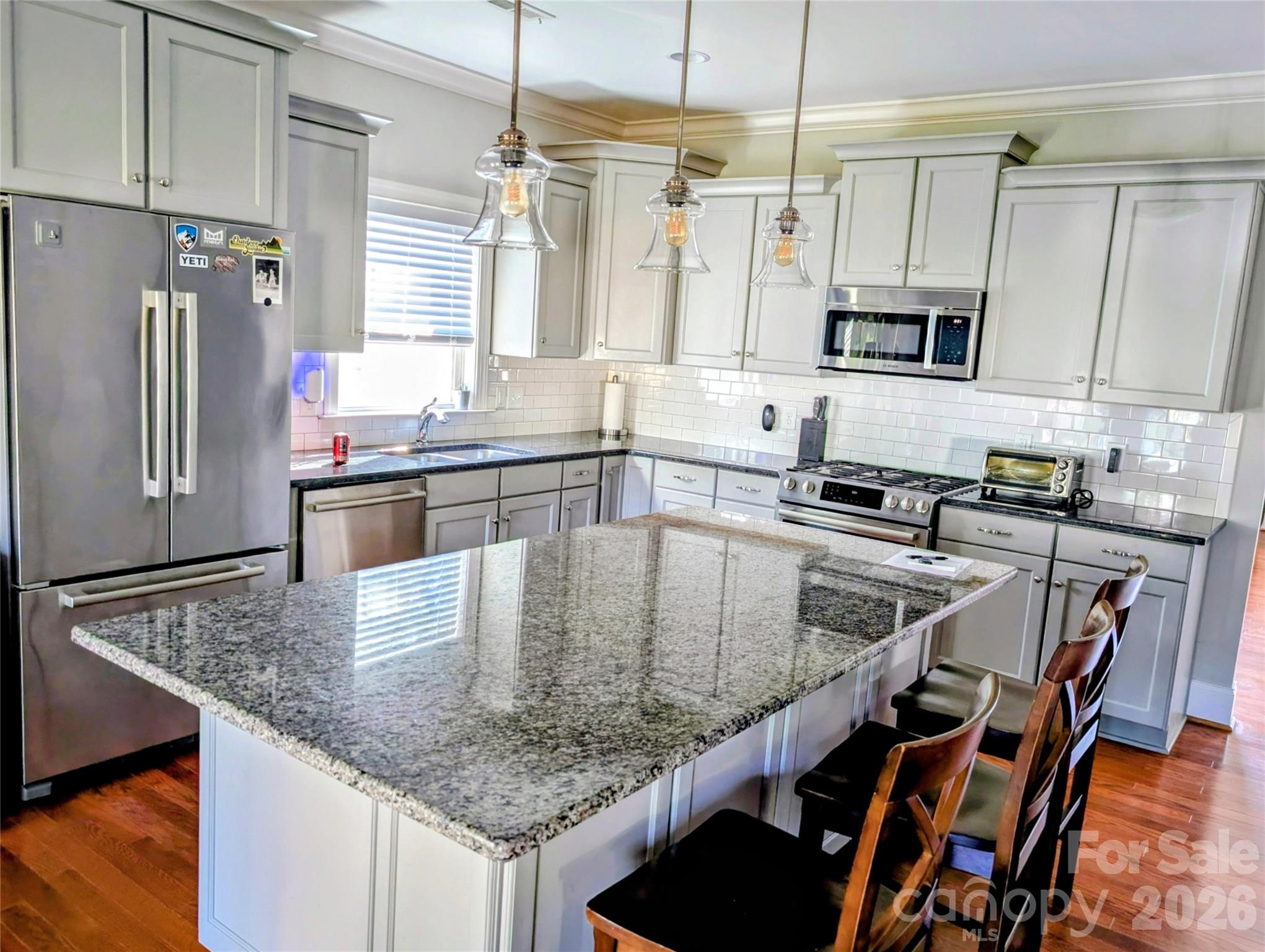 19934 Walter Henderson Road Cornelius, NC 28031 - Photo 12 of 35 a kitchen with stainless steel appliances granite countertop a sink a stove counter top space cabinets and stainless steel appliances