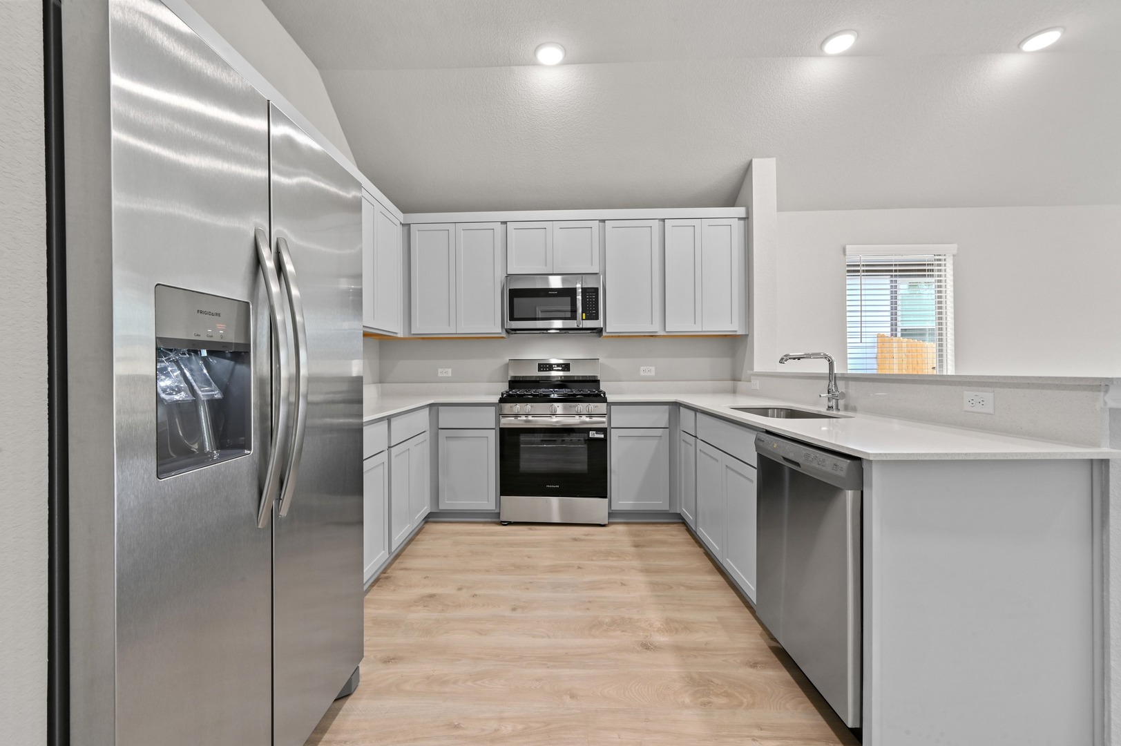 332 Bendecido Loop Elgin, TX 78621 - Photo 8 of 39 a kitchen with a refrigerator a sink and a stove top oven