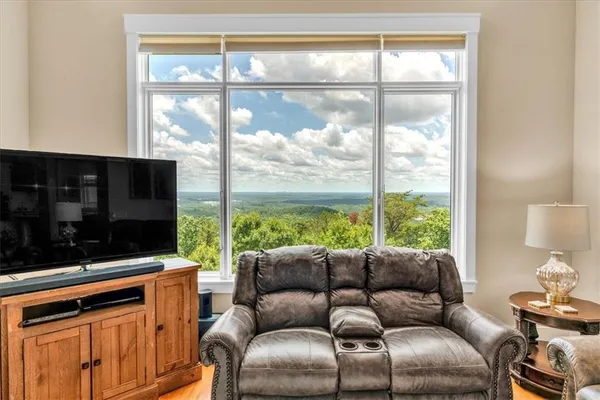 a bedroom with furniture and large windows