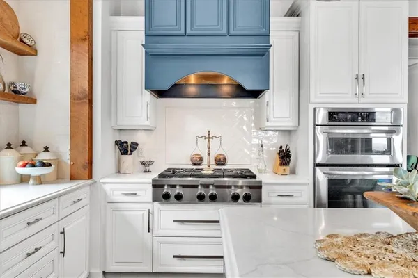 a kitchen with kitchen island a counter top space wooden floor and appliances