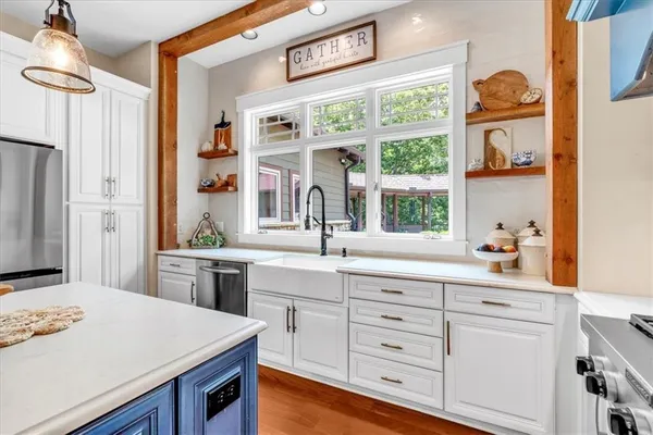 a kitchen with stainless steel appliances a sink and a refrigerator